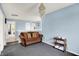 Cozy bonus room with blue walls, a charming chandelier and comfortable seating, ideal for relaxing and entertaining at 1571 N Creekwater Pass, Greenfield, IN 46140