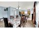 Open-concept living area with dining table and a view into the modern kitchen at 1571 N Creekwater Pass, Greenfield, IN 46140