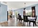 Open-concept living area with dining table and a view into the modern kitchen at 1571 N Creekwater Pass, Greenfield, IN 46140