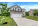 Charming two-story home with brick and siding, attached two-car garage and well-maintained lawn at 1571 N Creekwater Pass, Greenfield, IN 46140