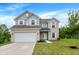 Charming two-story home with brick and siding, attached two-car garage and well-maintained lawn at 1571 N Creekwater Pass, Greenfield, IN 46140