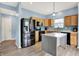 Bright kitchen featuring stainless steel appliances, wooden cabinets, and a stylish island at 1571 N Creekwater Pass, Greenfield, IN 46140