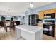 Spacious kitchen with stainless steel appliances opening up to a dining area and living space at 1571 N Creekwater Pass, Greenfield, IN 46140