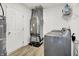 A laundry room with a modern washer and dryer, utility closet, and storage space at 1571 N Creekwater Pass, Greenfield, IN 46140
