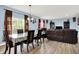 Open-concept living area with dining table and a view into the cozy living area at 1571 N Creekwater Pass, Greenfield, IN 46140