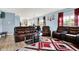 Bright living room featuring a leather sofa set, stylish decor, and an open layout flowing into the kitchen at 1571 N Creekwater Pass, Greenfield, IN 46140