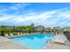 Community pool with plenty of lounge chairs, ideal for relaxing on a hot summer day in a friendly neighborhood at 1571 N Creekwater Pass, Greenfield, IN 46140