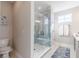 Modern bathroom featuring a glass shower with stylish blue-grey tiling and a built-in bench at 16067 Meadow Frost Ct, Fishers, IN 46037