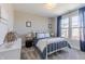 Comfortable bedroom with ample natural light, featuring a white bed frame and blue accents at 16067 Meadow Frost Ct, Fishers, IN 46037