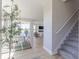 Bright dining area next to the staircase offers a view to the cozy living room with a fireplace at 16067 Meadow Frost Ct, Fishers, IN 46037