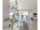 Bright dining area features light wood floors, modern lighting, and picturesque backyard views at 16067 Meadow Frost Ct, Fishers, IN 46037