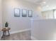 Bright hallway with decorative artwork, leading to additional rooms, perfect for Gathering living at 16067 Meadow Frost Ct, Fishers, IN 46037