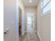 Upstairs hallway with natural light leading to the bedroom and bathroom, features a plush carpet at 16067 Meadow Frost Ct, Fishers, IN 46037