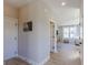 Bright hallway leading to a living room with hardwood floors and modern design features at 16067 Meadow Frost Ct, Fishers, IN 46037