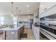 Bright and airy kitchen with stainless steel appliances, a modern island, and beautiful lighting at 16067 Meadow Frost Ct, Fishers, IN 46037