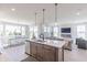 Open concept kitchen featuring an island, a dining area, and a living room with fireplace at 16067 Meadow Frost Ct, Fishers, IN 46037