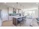Kitchen with island seating, stainless appliances, white cabinets, and an adjacent dining area at 16067 Meadow Frost Ct, Fishers, IN 46037