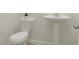 Modern powder room featuring a sleek pedestal sink and water closet at 16906 Daly Dr, Noblesville, IN 46062