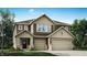 Two-story home showcasing a two-car garage, lovely landscaping, and a charming front porch entrance at 16926 Daly Dr, Noblesville, IN 46062