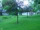 Expansive green backyard with mature trees and a shed at 1808 Orchid Ct, Indianapolis, IN 46219