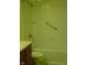 Clean bathroom featuring a tub and tiled surround, with safety grab bar at 1808 Orchid Ct, Indianapolis, IN 46219