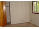Simple bedroom with a closet and a window, featuring neutral walls and carpeted floors at 1808 Orchid Ct, Indianapolis, IN 46219