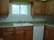 A kitchen sink and dishwasher beneath a bright window at 1808 Orchid Ct, Indianapolis, IN 46219