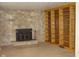 Living room showcasing stone fireplace and built-in wooden bookcase at 1808 Orchid Ct, Indianapolis, IN 46219