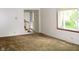 Spacious living room featuring a large window and entry stairway at 1808 Orchid Ct, Indianapolis, IN 46219