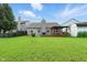 Spacious backyard featuring a deck, a lush green lawn, and a fence, perfect for outdoor activities at 19489 Prairie Crossing Dr, Noblesville, IN 46062