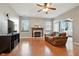 Bright living room with hardwood floors, ceiling fan and fireplace, perfect for relaxing and entertaining at 19489 Prairie Crossing Dr, Noblesville, IN 46062