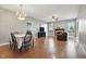 Open-concept living room with hardwood floors, fireplace, and ample space for dining and lounging at 19489 Prairie Crossing Dr, Noblesville, IN 46062