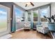Bright sunroom with large windows, ceiling fan, and comfortable seating, ideal for relaxation at 19489 Prairie Crossing Dr, Noblesville, IN 46062