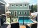 Backyard view of pool with lounge furniture and well-maintained lawn at 2050 N Alabama St, Indianapolis, IN 46202
