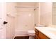 This bathroom features a tub shower, toilet, wood cabinets, and tile-look vinyl flooring at 209 Faulkner Ct # 102, Carmel, IN 46032