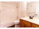 This bathroom features a tub shower, toilet, wood cabinets, a sink, and a mirror at 209 Faulkner Ct # 102, Carmel, IN 46032