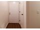 Entryway features a wood floor, a white front door, and a coat closet at 209 Faulkner Ct # 102, Carmel, IN 46032