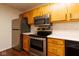 The kitchen features stainless steel appliances, light oak cabinets, and white countertops at 209 Faulkner Ct # 102, Carmel, IN 46032
