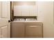 This laundry room features white cabinets, a washing machine, and a clothes dryer at 209 Faulkner Ct # 102, Carmel, IN 46032