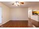 Open floor plan with hardwood floors, a ceiling fan, and a view of the kitchen at 209 Faulkner Ct # 102, Carmel, IN 46032