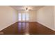 Open living room featuring hardwood floors, a ceiling fan, and white walls at 209 Faulkner Ct # 102, Carmel, IN 46032