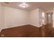 An open concept living room featuring a smooth surface floor and a connecting hallway at 209 Faulkner Ct # 102, Carmel, IN 46032