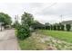 Backyard featuring a metal carport with ample parking, a basketball hoop, and a grassy area at 2249 Maple St, Columbus, IN 47201