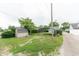 Large, open backyard featuring a carport, storage shed, and room for outdoor activities at 2249 Maple St, Columbus, IN 47201