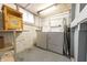 Basement laundry room with a white washer and dryer, utility sink, and plenty of storage space at 2249 Maple St, Columbus, IN 47201