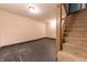 Partially finished basement with paneled stairs and an open area ready for customization at 2249 Maple St, Columbus, IN 47201