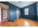 Bedroom boasts hardwood floors, natural light, and classic design with a door and trim at 2249 Maple St, Columbus, IN 47201