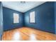 Cozy bedroom featuring hardwood floors, two windows providing plenty of natural light at 2249 Maple St, Columbus, IN 47201