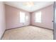 Bedroom featuring neutral carpet and walls, two windows with trim, and a ceiling fan at 2249 Maple St, Columbus, IN 47201