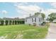 Well-maintained home featuring a neatly landscaped lawn, gray siding and black shutters, and a backyard at 2249 Maple St, Columbus, IN 47201